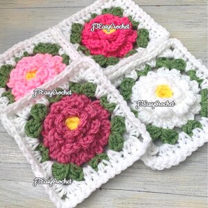 Set of four 3D white granny squares with raised borders laying on a flat surface. Each granny square has a white or shades of pink rose or peony with 2 layers of petals surrounded with green leaves.
