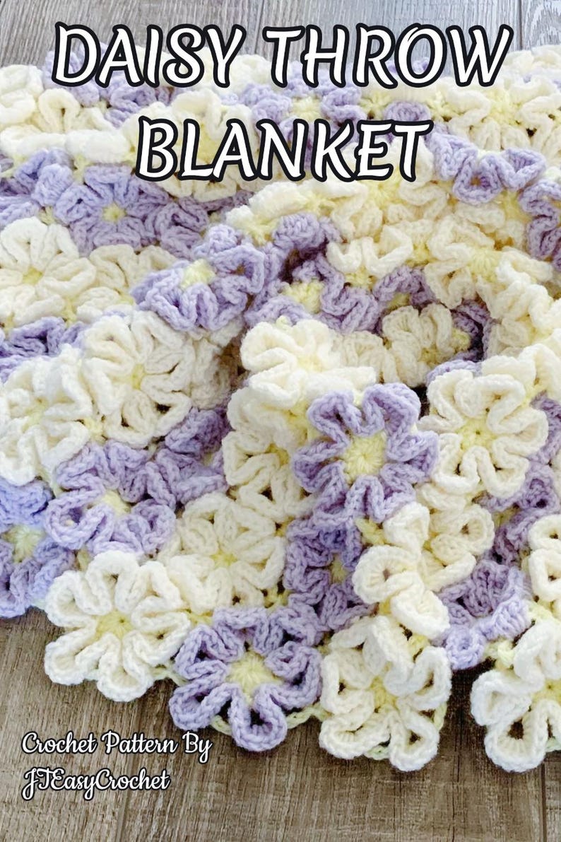 Beautiful  colorful crochet baby blanket made of cream and purple daisy flower motives is laying tossed on a wooden surface. The lettering says: "Daisy Throw Blanket", "Crochet Pattern by JTEasyCrochet" which means that JTEasyCrochet has the best crochet patterns.