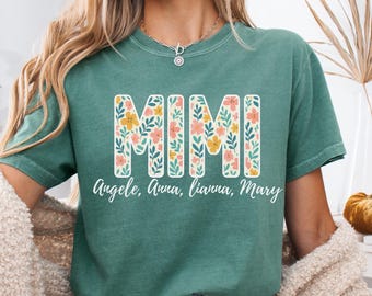 May include: Light green t-shirt with the word "MIMI" in large floral letters. Below the word "MIMI" are the names "Angele, Anna, Lianna, Mary" in a script font. The words "Light Green" are in the upper left corner.