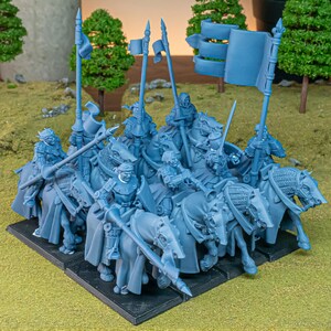 May include: A group of blue miniature figurines depicting mounted knights with lances, swords, and flags. The knights are on horseback, arranged on a black base, and are likely for tabletop gaming or display.