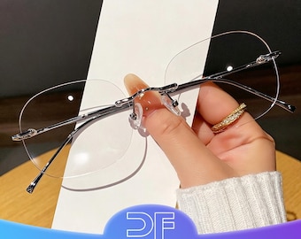 Minimalist rimless metal glasses; unisex.
