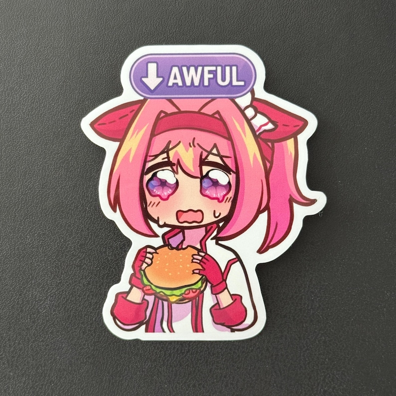 May include: A sticker featuring a cartoon anime character with pink hair and crying eyes, holding a burger. Above the character is a purple banner with the word "AWFUL" and a downward arrow.