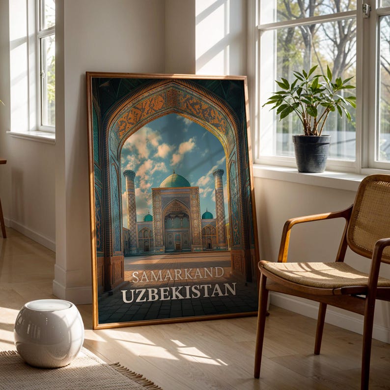 May include: A framed print featuring the Samarkand, Uzbekistan, with an arched entrance framing a view of a mosque with turquoise domes and minarets. The print has a gold-colored frame and is displayed in a well-lit room.