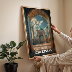 May include: A framed print featuring a detailed architectural illustration of a building with a turquoise dome and minarets, set against a blue sky. The print includes the text "SAMARKAND UZBEKISTAN" in a serif font.