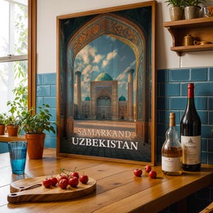 May include: Framed print of Samarkand, Uzbekistan, featuring a detailed architectural view through an archway. The image showcases a mosque with turquoise domes and minarets. The print is displayed on a wooden surface with wine bottles, a glass, and cherries.
