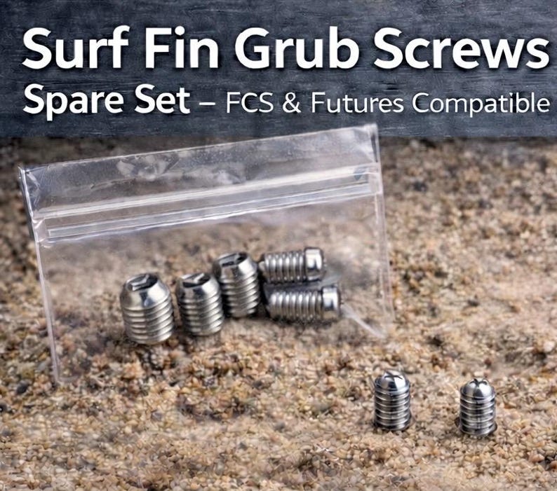 May include: A clear plastic bag containing several silver-colored surf fin grub screws. The text "Surf Fin Grub Screws Spare Set - FCS & Futures Compatible" is displayed at the top of the image. The screws are designed for surfboards.