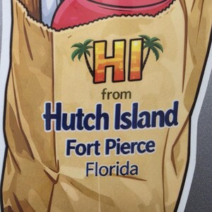 May include: A sticker featuring a brown paper bag with a red-topped bottle peeking out. The bag has the words "HI from Hutch Island Fort Pierce Florida" in blue and orange text, with palm tree graphics.