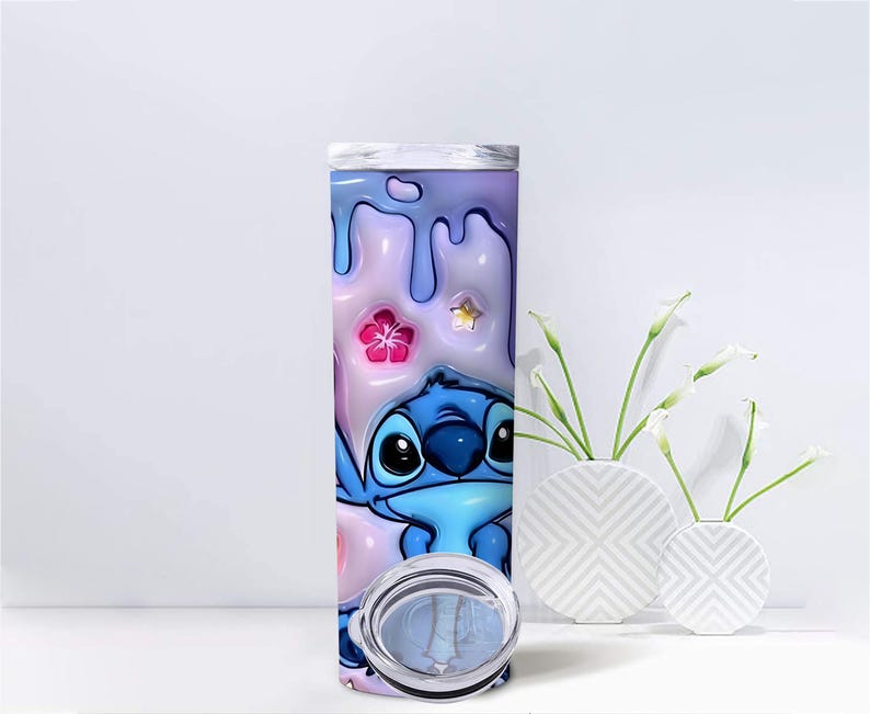 May include: A tall, stainless steel tumbler featuring a cartoon character, Stitch, in shades of blue. The background has a pastel color scheme with dripping paint and floral accents. The tumbler includes a clear lid.