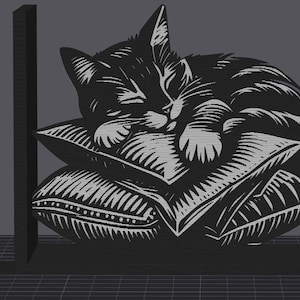 Puede incluir: Sujetalibros de gato en blanco y negro. El diseño presenta un gato durmiendo sobre almohadas. Los sujetalibros están hechos de un material oscuro y están diseñados para sujetar los libros en posición vertical. El gato y las almohadas están detallados con un estilo linóleo.