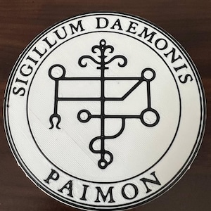 May include: A round, white and black graphic featuring the text "SIGILLUM DAEMONIS" and "PAIMON" in a circular design. The central image is a complex, black symbol.