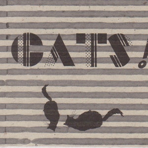May include: A book with a striped cover and the word "CATS!" in bold, black letters. The cover also features a silhouette of a cat.