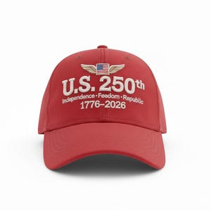 May include: A red baseball cap with the text "U.S. 250th" in white, along with the words "Independence &bull; Freedom &bull; Republic 1776-2026". The cap features a design of wings and the American flag.