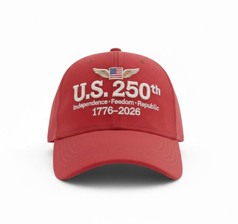 May include: A red baseball cap with the text "U.S. 250th" in white, along with the words "Independence &bull; Freedom &bull; Republic 1776-2026". The cap features a design of wings and the American flag.