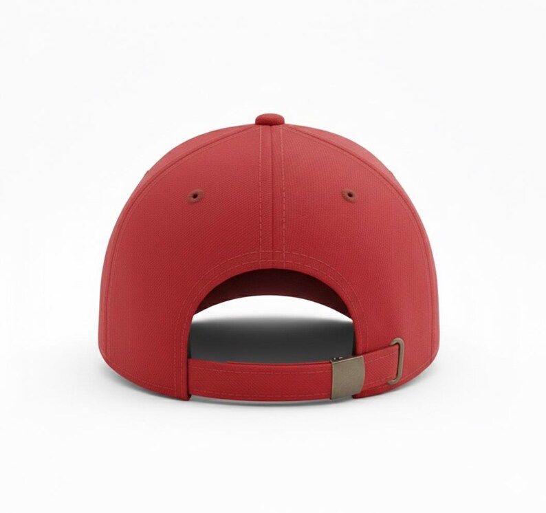 May include: A solid red baseball cap, viewed from the back, with a curved brim and a metal clasp closure. The cap has a classic six-panel design with a button on top. The adjustable strap allows for a comfortable fit.