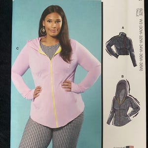 May include: McCall's sewing pattern M8366, size W3 (30W-38W). The pattern features a woman wearing a pink zip-up hoodie with yellow trim and houndstooth pants. Includes illustrations of jacket options. Designed and printed in the USA.