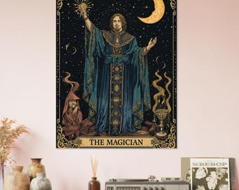 May include: A framed tarot card print featuring "The Magician." The artwork depicts a robed figure holding a staff under a crescent moon and starry night sky. The color palette includes teal, gold, and brown tones. The text "THE MAGICIAN" is at the bottom.