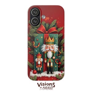 May include: A red phone case featuring a Christmas theme. The design includes a large gift box with a red bow, two nutcrackers, and festive greenery. The case has a glossy finish and the text "Visions by Astrid" at the bottom.