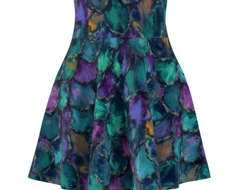 May include: A flared skirt featuring an abstract pattern in shades of teal, purple, and yellow. The design resembles overlapping brushstrokes, creating a textured appearance. The skirt has a high waist and a flowing silhouette.