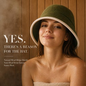 May include: An olive green wool sauna hat with a cream-colored brim edge. The text on the image reads: YES. THERE'S A REASON FOR THE HAT. Natural Wool Helps Shield Your Head From Intense Sauna Heat. The hat has a rounded crown and a wide brim.