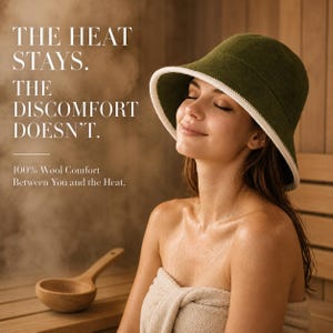 May include: An olive green wool sauna hat with a white trim along the brim. The text on the image reads: THE HEAT STAYS. THE DISCOMFORT DOESN'T. 100% Wool Comfort Between You and the Heat. A wooden ladle is visible in the lower left corner.