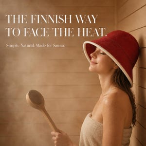 May include: A deep red sauna hat with a white trim and a long-handled wooden ladle. The text reads: THE FINNISH WAY TO FACE THE HEAT. Simple. Natural. Made for Sauna. The hat has a wide brim and a rounded crown, designed for use in a steam-filled room.