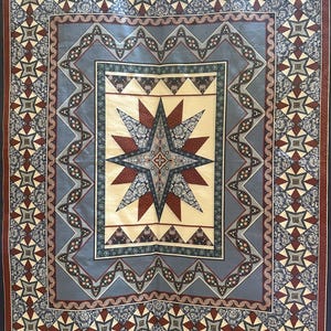May include: A large, rectangular quilt with a complex geometric design. The quilt features a central starburst pattern in cream, burgundy, and gray, surrounded by multiple borders with floral and geometric motifs. The color palette includes navy, gray, cream, and burgundy.