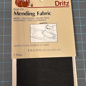 May include: A package of Dritz iron-on mending fabric. The package is tan with black text and a graphic of an iron. The fabric is black and measures 6 inches by 13 inches.
