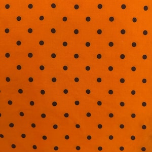 Orange with black polka dots Halloween fabric