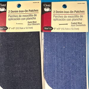 May include: Two denim iron-on patches in dark blue and faded blue. Each patch is 5" x 5" (12.7cm x 12.7cm). The packaging reads "2 Denim Iron-On Patches" and "Parches de mezclilla de aplicación con plancha".