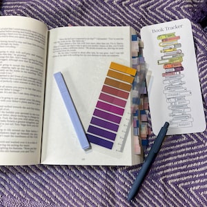 May include: A stationery set including a book review sheet, a book tracker bookmark, a magnetic bookmark, a highlighter, a black gel pen, a colored gel pen, a pack of annotation tabs, and six stickers with text like read, books, and slow burn.