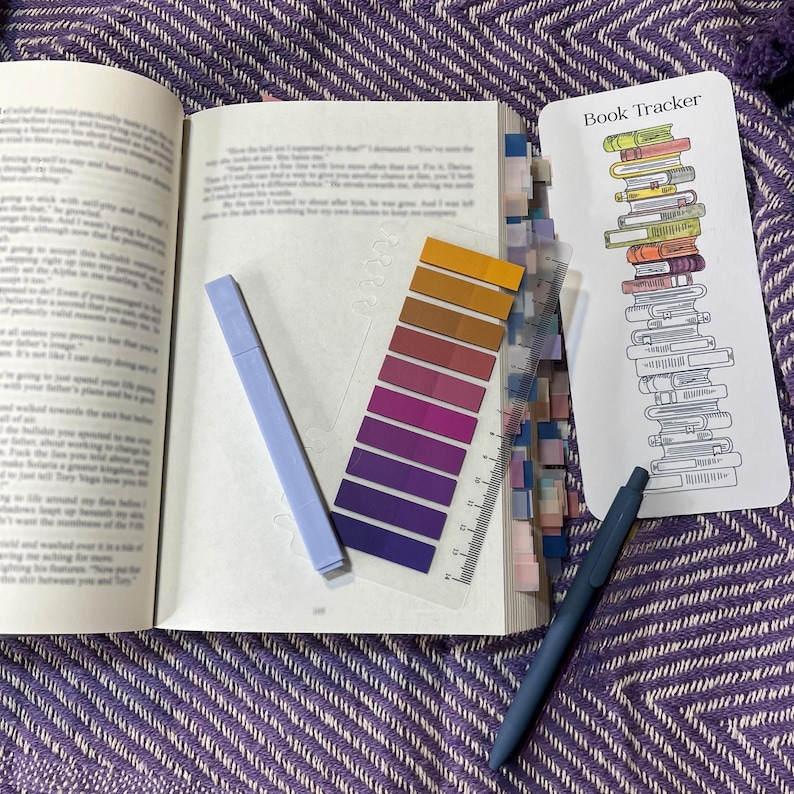 May include: A stationery set including a book review sheet, a book tracker bookmark, a magnetic bookmark, a highlighter, a black gel pen, a colored gel pen, a pack of annotation tabs, and six stickers with text like read, books, and slow burn.