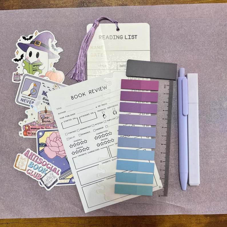May include: A stationery set including a book review sheet, a book tracker bookmark, a magnetic bookmark, a highlighter, a black gel pen, a colored gel pen, a pack of annotation tabs, and six stickers with text like read, books, and slow burn.