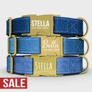 May include: Three blue denim dog collars with gold-colored buckles. Each collar has a name and phone number printed on the buckle. The top and bottom collars say "Stella", and the middle collar says "Bella".