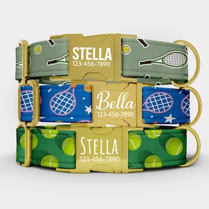May include: Three dog collars with gold-colored buckles. The top collar is green with tennis racket graphics and the name "Stella". The middle collar is blue with tennis racket graphics and the name "Bella". The bottom collar is green with tennis ball graphics and the name "Stella".