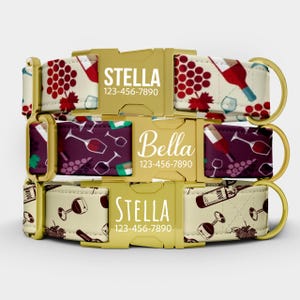 May include: Three dog collars with gold buckles. The top and bottom collars have a cream background with wine bottle and grape designs. The middle collar has a purple background with wine glass designs. Each collar has a name and phone number.