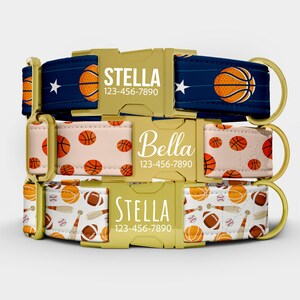 May include: Three personalized dog collars with gold-colored hardware. The top collar is navy blue with basketball graphics and the name "Stella". The middle collar is peach with basketballs and the name "Bella". The bottom collar has sports equipment.
