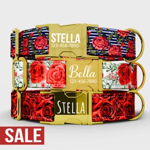 May include: Three dog collars with gold-coloured buckles. The top collar has a navy blue and white striped pattern with red roses and the name "Stella" and a phone number. The middle collar has a white background with red roses and the name "Bella" and a phone number. The bottom collar has a red rose pattern and the name "Stella".