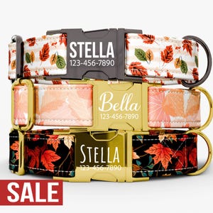May include: Three personalized dog collars with autumn leaf patterns. The collars feature names and phone numbers on the buckles. One collar is white with orange and green leaves, another is peach with orange leaves, and the third is black with red leaves. A red "SALE" banner is at the bottom.