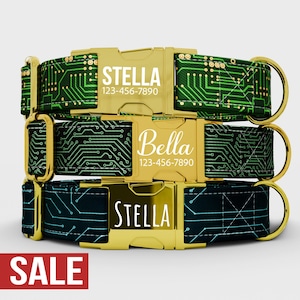 May include: Three dog collars stacked on top of each other. The collars have a circuit board design in green and blue on a black background. Each collar has a gold-colored buckle with a name and phone number printed on it.