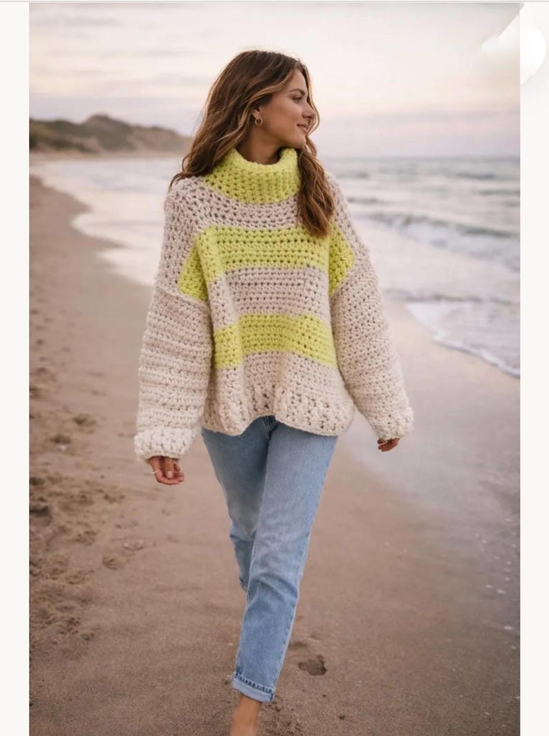 May include: A chunky crochet sweater featuring a high turtleneck collar and long sleeves. The garment displays a horizontal striped pattern in alternating bands of cream and neon yellow yarn, crafted with a visible, textured stitch throughout.
