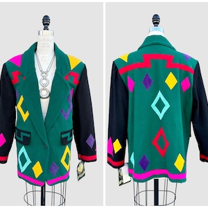 May include: A forest green blazer featuring black sleeves and a vibrant geometric pattern of diamonds and zigzags in hot pink, yellow, purple, and light blue. The jacket has a notched lapel, two front pockets, and a single button closure.