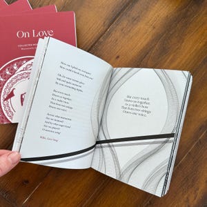 May include: An open book with a white background and black text. The book is titled "On Love" and features a poem by Rilke. The poem is about love and how it draws two people together.