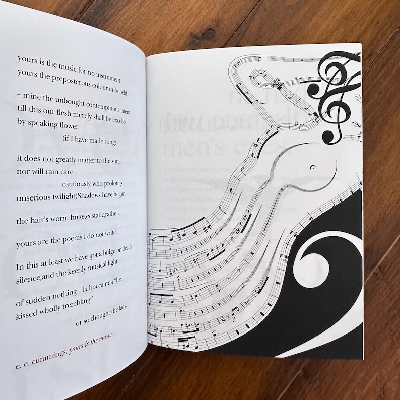 May include: A book with a black and white illustration of musical notes on the right page. The left page features a poem by e. e. cummings titled "yours is the music".