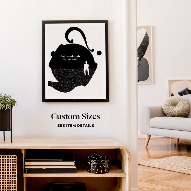 May include: Black and white minimalist art print featuring a silhouette of a person standing in a large, abstract shape with the text "Do I dare disturb the universe?"  The print is framed in a black frame and hanging on a white wall.