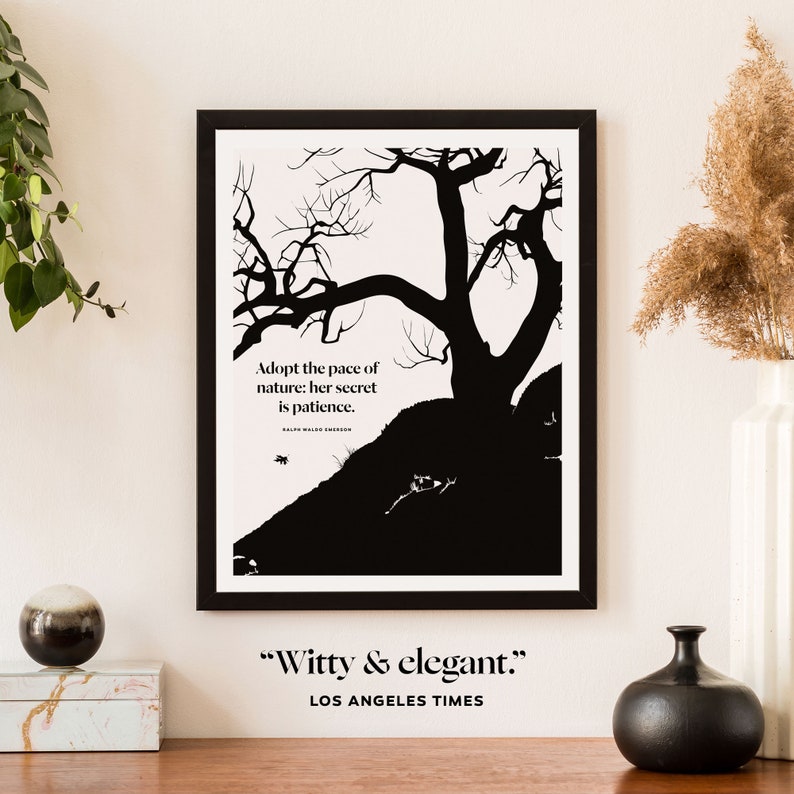 May include: Black and white print of a tree silhouette with the quote "Adopt the pace of nature: her secret is patience." by Ralph Waldo Emerson. The print is framed in black and has the text "Witty & elegant." and "Los Angeles Times" below the image.