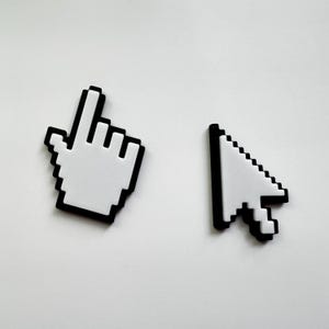 May include: Two pixelated computer cursor icons: a white hand pointer and a white arrow pointer, both outlined in black. The hand pointer is angled left, and the arrow pointer is angled up and to the right. The background is plain white.