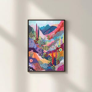 May include: A framed art print featuring a colorful, abstract landscape. The artwork depicts rolling hills and mountains in shades of blue, pink, orange, and green, with floral and plant details. The print is in a black frame.