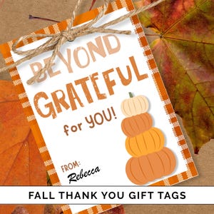 May include: A white gift tag with orange trim and a twine bow. The tag reads "BEYOND GRATEFUL for YOU!" with a stack of pumpkins. The tag is on a background of fall leaves. The text "FALL THANK YOU GIFT TAGS" is at the bottom.