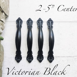 May include: Three black Victorian style cabinet pulls with a 2-5" center to center spacing.