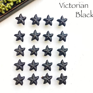 May include: Twenty black starfish-shaped cabinet knobs with a Victorian Black finish.